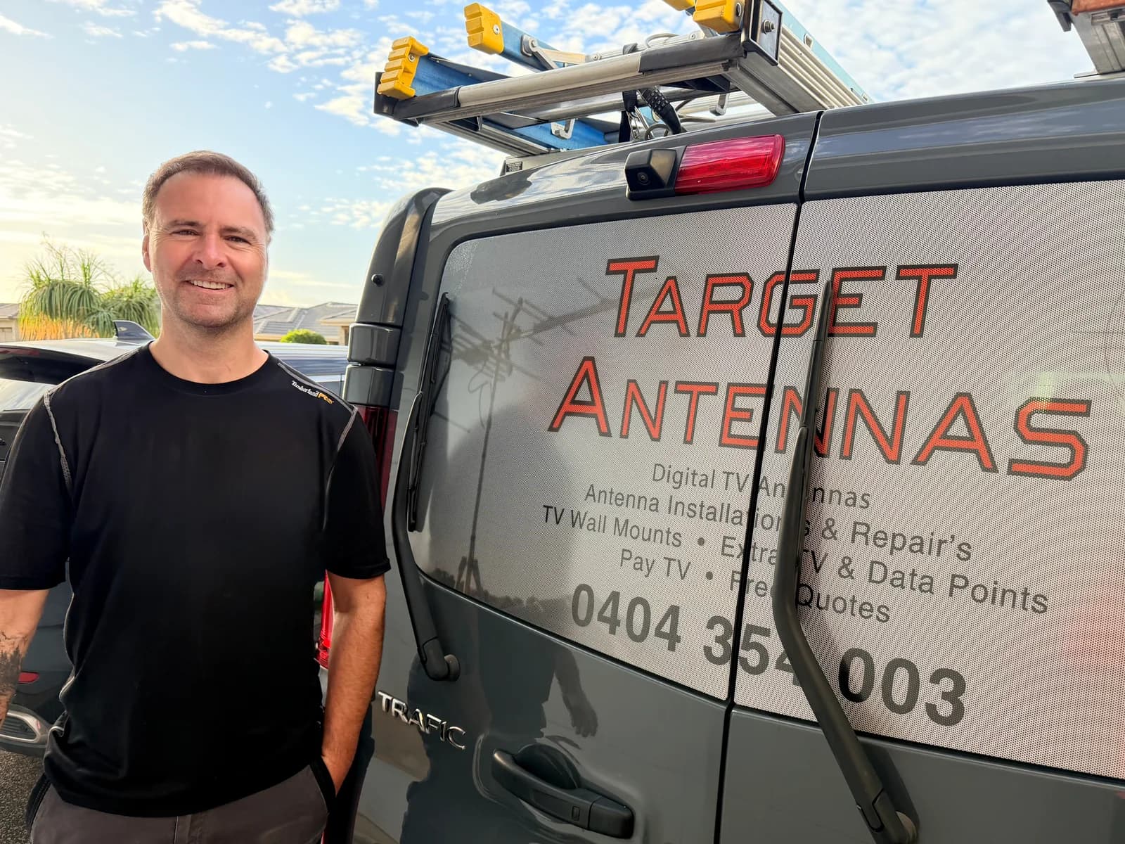 Darrel Carr, owner of Target Antennas, standing next to his work van in Adelaide