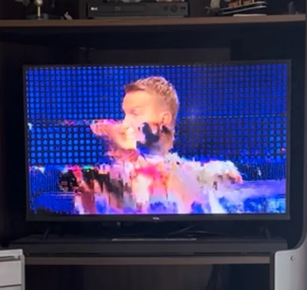 A TV picture breaking up into coloured blocks, a classic sign of pixelation from weak signal