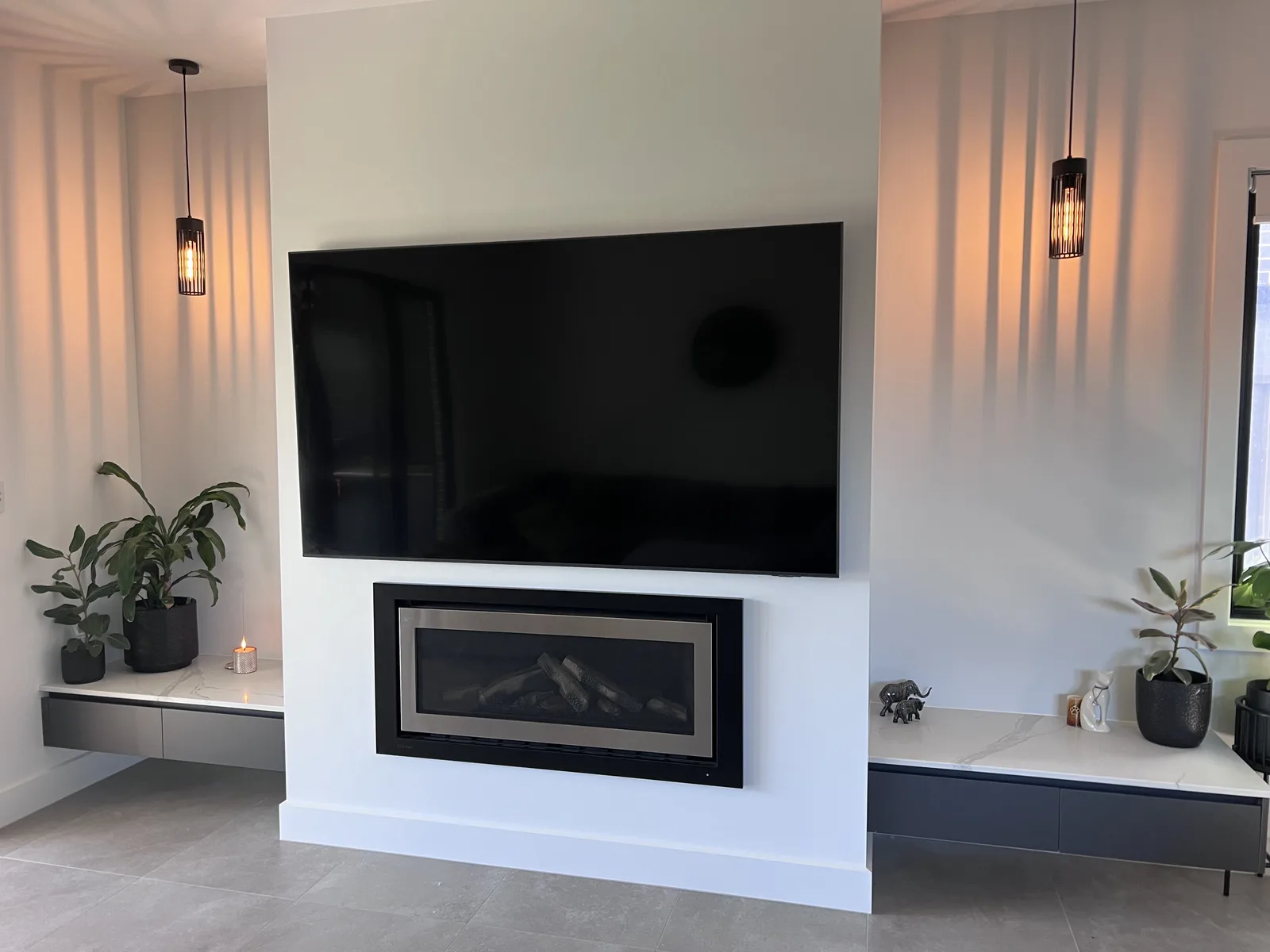 Flat-screen TV wall mounted above a fireplace in an Adelaide home